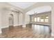 Expansive living room with wood floors, neutral walls, archways and bright natural light at 22296 E Maya Rd, Queen Creek, AZ 85142
