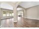 Spacious living room boasts wood-look tile flooring, grand archways and abundant natural light from large windows at 22296 E Maya Rd, Queen Creek, AZ 85142