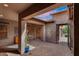 Covered patio with brick pavers and view to a grassy yard and fence with a pool and spa at 22296 E Maya Rd, Queen Creek, AZ 85142