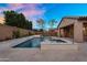 Backyard pool area featuring a water feature and tiled spa with views of the covered patio and desert landscaping at 22296 E Maya Rd, Queen Creek, AZ 85142