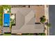 Overhead view of a house with a backyard featuring a pool, jacuzzi, and lounging area with two umbrellas at 22302 E Russet Rd, Queen Creek, AZ 85142