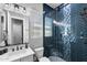 Stylish bathroom featuring modern fixtures, blue herringbone tile shower, and a vanity with ample storage and counter space at 22302 E Russet Rd, Queen Creek, AZ 85142