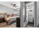 Relaxing bedroom featuring a ceiling fan and an ensuite bathroom with a modern vanity, adding convenience and privacy at 22302 E Russet Rd, Queen Creek, AZ 85142
