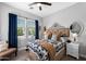 Comfortable bedroom boasts a decorative headboard, dark curtains, and patterned bedding, creating a warm and inviting ambiance at 22302 E Russet Rd, Queen Creek, AZ 85142