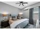 Calm bedroom with a cozy bed, decorative pillows, and an elegant fan, perfect for relaxation and restful nights at 22302 E Russet Rd, Queen Creek, AZ 85142