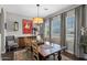 Dining room with hardwood floors, a large chandelier, and natural light from the expansive windows at 22302 E Russet Rd, Queen Creek, AZ 85142