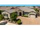 Beautiful stone accents highlight this single-story home with manicured landscaping and a paver driveway at 22302 E Russet Rd, Queen Creek, AZ 85142