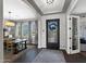 Elegant foyer featuring hardwood floors, decorative rug, and a view of the dining area with a large chandelier at 22302 E Russet Rd, Queen Creek, AZ 85142