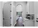 Hallway with tiled floors and white cabinets leading to the kitchen at 22302 E Russet Rd, Queen Creek, AZ 85142