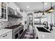 Modern kitchen featuring custom white cabinetry, professional-grade appliances, and sleek countertops at 22302 E Russet Rd, Queen Creek, AZ 85142