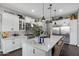 Gourmet kitchen boasts stainless steel appliances, a large island with seating, and stylish pendant lighting at 22302 E Russet Rd, Queen Creek, AZ 85142