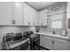 Modern laundry room with front load washer/dryer units, sleek countertops, and ample cabinet space at 22302 E Russet Rd, Queen Creek, AZ 85142