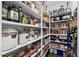 Organized pantry with white shelving stocked with an array of food items and kitchen appliances at 22302 E Russet Rd, Queen Creek, AZ 85142