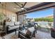 Inviting covered patio with a comfortable seating area and view of the pool and backyard at 22302 E Russet Rd, Queen Creek, AZ 85142
