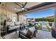 Inviting covered patio with a comfortable seating area and view of the pool and backyard at 22302 E Russet Rd, Queen Creek, AZ 85142