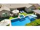 Beautiful backyard featuring a pool with in-pool barstools, jacuzzi, and lounge chairs under umbrellas at 22302 E Russet Rd, Queen Creek, AZ 85142