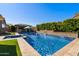 Beautiful backyard pool and spa with an outdoor kitchen and well-manicured landscaping at 22302 E Russet Rd, Queen Creek, AZ 85142