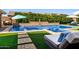 Relaxing backyard pool and spa with a stone waterfall feature and lush landscaping at 22302 E Russet Rd, Queen Creek, AZ 85142