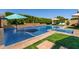 Sparkling pool featuring a tanning ledge, manicured landscaping, and soothing water feature at 22302 E Russet Rd, Queen Creek, AZ 85142