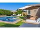 Serene backyard pool and spa area with a nearby fire pit and lounge chairs at 22302 E Russet Rd, Queen Creek, AZ 85142