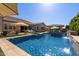 Beautiful pool area with sparkling blue water and a tranquil water feature at 22302 E Russet Rd, Queen Creek, AZ 85142