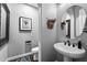 Charming powder room features a pedestal sink, oval mirror, and decorative accents for a welcoming and stylish space at 22302 E Russet Rd, Queen Creek, AZ 85142