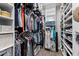 Spacious walk-in closet with ample hanging space, shelving, and storage solutions for organized living and convenience at 22302 E Russet Rd, Queen Creek, AZ 85142