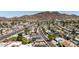 Aerial view of a neighborhood showcasing well-maintained homes and tree-lined streets against a mountain backdrop at 2236 W Shaw Butte Dr, Phoenix, AZ 85029