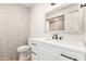 Updated bathroom with a sleek vanity, modern fixtures, and patterned accent wall at 2236 W Shaw Butte Dr, Phoenix, AZ 85029