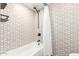 Stylish bathroom featuring a shower with a patterned accent wall and modern fixtures at 2236 W Shaw Butte Dr, Phoenix, AZ 85029