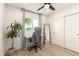 Inviting bedroom featuring a desk, ceiling fan, sliding closet doors, and natural light from the window at 2236 W Shaw Butte Dr, Phoenix, AZ 85029
