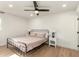 Bright bedroom featuring a black metal bed frame, neutral-toned bedding, and light wood-look flooring at 2236 W Shaw Butte Dr, Phoenix, AZ 85029