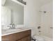 Bathroom showcasing a wood vanity, a neutral marble sink, and a toilet next to a tub and shower at 225 N Standage -- # 30, Mesa, AZ 85201