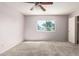 Bedroom features neutral carpet, ceiling fan and a window at 225 N Standage -- # 30, Mesa, AZ 85201