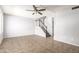 Open-concept living room featuring tile floors, a ceiling fan and staircase at 225 N Standage -- # 30, Mesa, AZ 85201