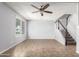 Cozy living room with a ceiling fan, natural light, tile flooring and a staircase at 225 N Standage -- # 30, Mesa, AZ 85201