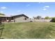 Expansive backyard with lush lawn, enclosed patio, and plenty of room for outdoor activities at 232 W San Angelo St, Gilbert, AZ 85233