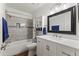 Bathroom featuring modern fixtures, updated vanity, bathtub with tile surround, and bright lighting at 232 W San Angelo St, Gilbert, AZ 85233