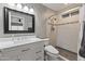 Well-lit bathroom with marble countertops, stylish mirror, and a walk-in shower with glass door at 232 W San Angelo St, Gilbert, AZ 85233