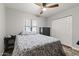 Cozy bedroom with neutral walls, ceiling fan, a window and closet with white panel doors at 232 W San Angelo St, Gilbert, AZ 85233