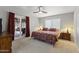 Cozy main bedroom with sliding glass doors to patio, fan, carpet flooring, and warm lighting at 232 W San Angelo St, Gilbert, AZ 85233