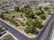 The aerial view captures the neighborhood park with green spaces, mature trees, and modern playground equipment at 232 W San Angelo St, Gilbert, AZ 85233
