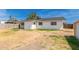Backyard with partial grass and dirt, showcasing the home's exterior and storage at 234 S Neely St, Gilbert, AZ 85233