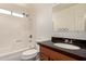 Bathroom featuring a shower-tub combo and a vanity with a dark countertop at 234 S Neely St, Gilbert, AZ 85233