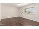 Bedroom with ceiling fan and hardwood flooring, lit by a window at 234 S Neely St, Gilbert, AZ 85233