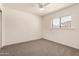 Bedroom with carpet flooring, ceiling fan, and a window providing natural light at 234 S Neely St, Gilbert, AZ 85233