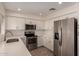 Stylish kitchen featuring stainless steel appliances, white cabinetry, and ample counter space, perfect for cooking at 234 S Neely St, Gilbert, AZ 85233