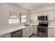 Bright kitchen features subway tile backsplash, stainless steel appliances, and white cabinetry at 234 S Neely St, Gilbert, AZ 85233