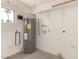 Utility room showing water heater, shelving, and small window at 234 S Neely St, Gilbert, AZ 85233