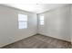 Carpeted bedroom with white walls and natural light from two windows with coverings at 2491 N 149Th Ln, Goodyear, AZ 85395